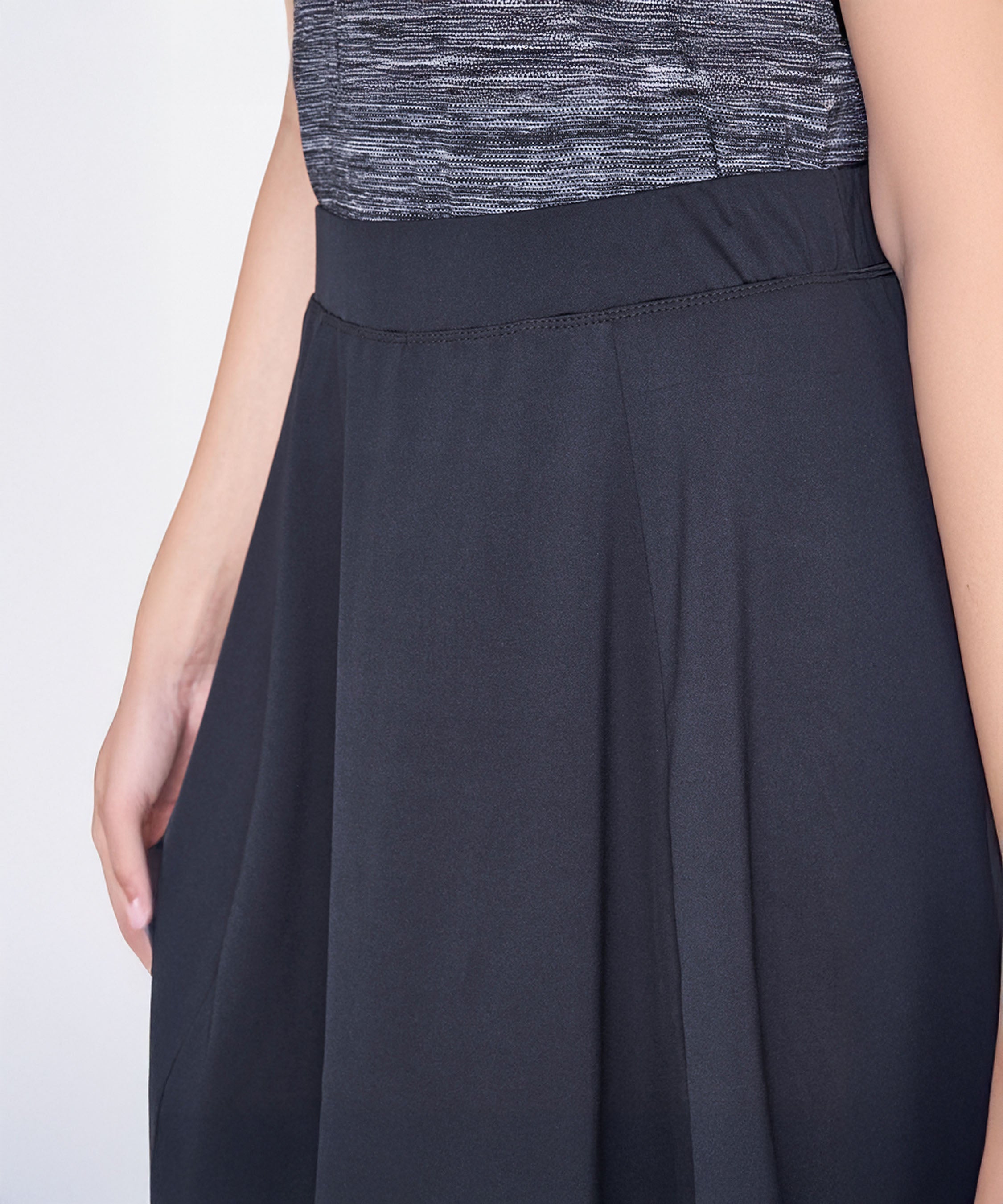 A person wearing the Grey Skirt is shown from shoulder to mid-thigh.