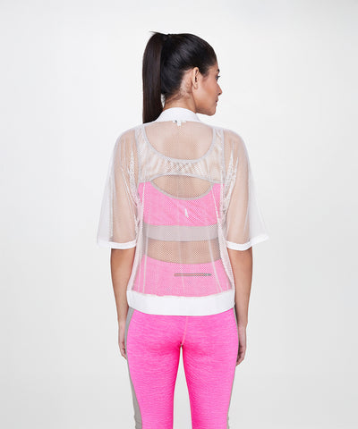 A woman with a ponytail is shown from the back wearing the White Sheer Jacket over a pink sports bra and pink leggings.