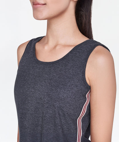 A woman, shown from the shoulders up, wears a Grey Sleeveless Tank Top featuring red and white side stripes.