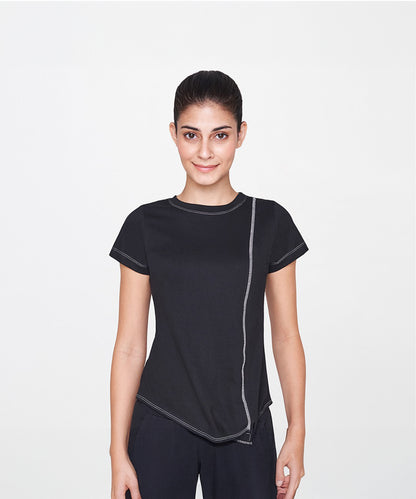 A woman with dark hair in a ponytail wears the Black T-Shirt with white stitching, smiling—an essential piece that adds classic style to any casual outfit.