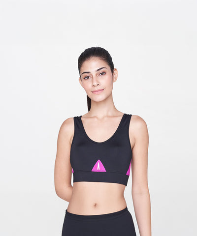 A woman models the Black and Pink Sports Bra, featuring vibrant pink accents, against a plain white background.