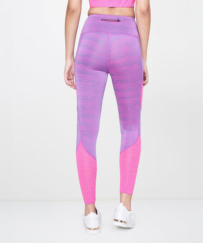 A person wearing the Pink Leggings paired with white sneakers and purple athleisure stands with their back to the camera.