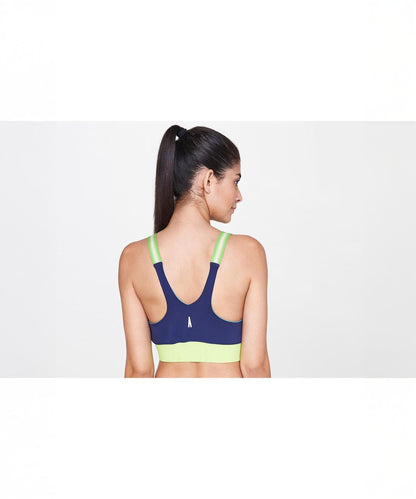 Woman with a ponytail wears the Zipped Blue and Neon Bra, viewed from the back against a white background.