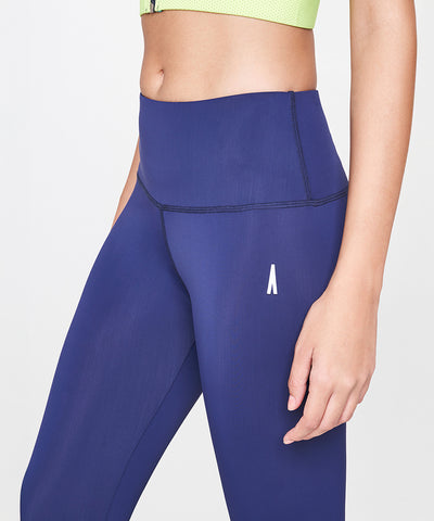 Model wearing Blue and Neon Green Leggings, shown from midriff to thigh.