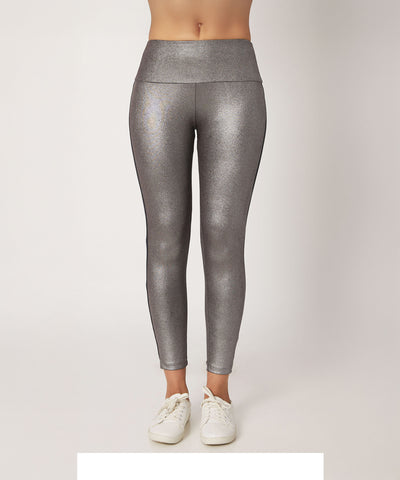 A person wearing High Waisted Metallic Leggings TLC116 in shiny silver, styled with white sneakers, shown from waist to feet.