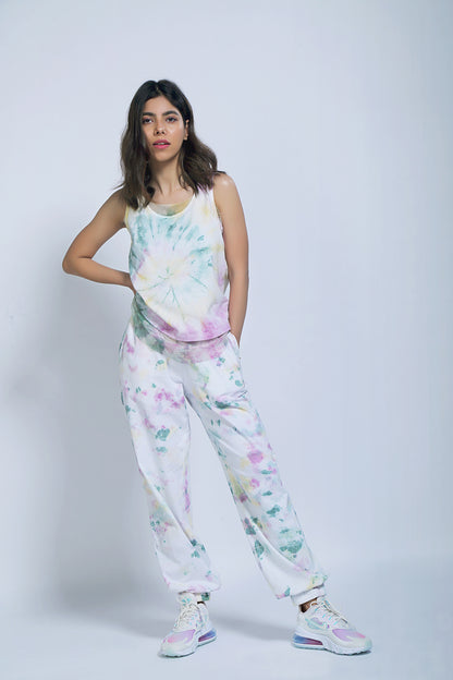 Woman wearing Comfort Fit Joggers and a Netted Tank Top, posing with one hand on her hip against a plain background.