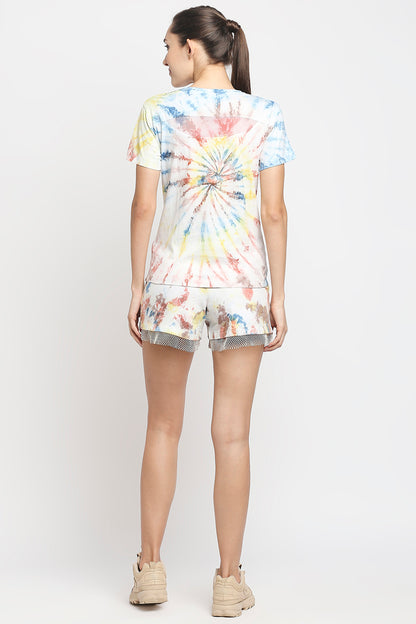 Woman facing away in the Netted Shorts and 100% cotton Comfort Tee, with her hair in a ponytail and beige sneakers.