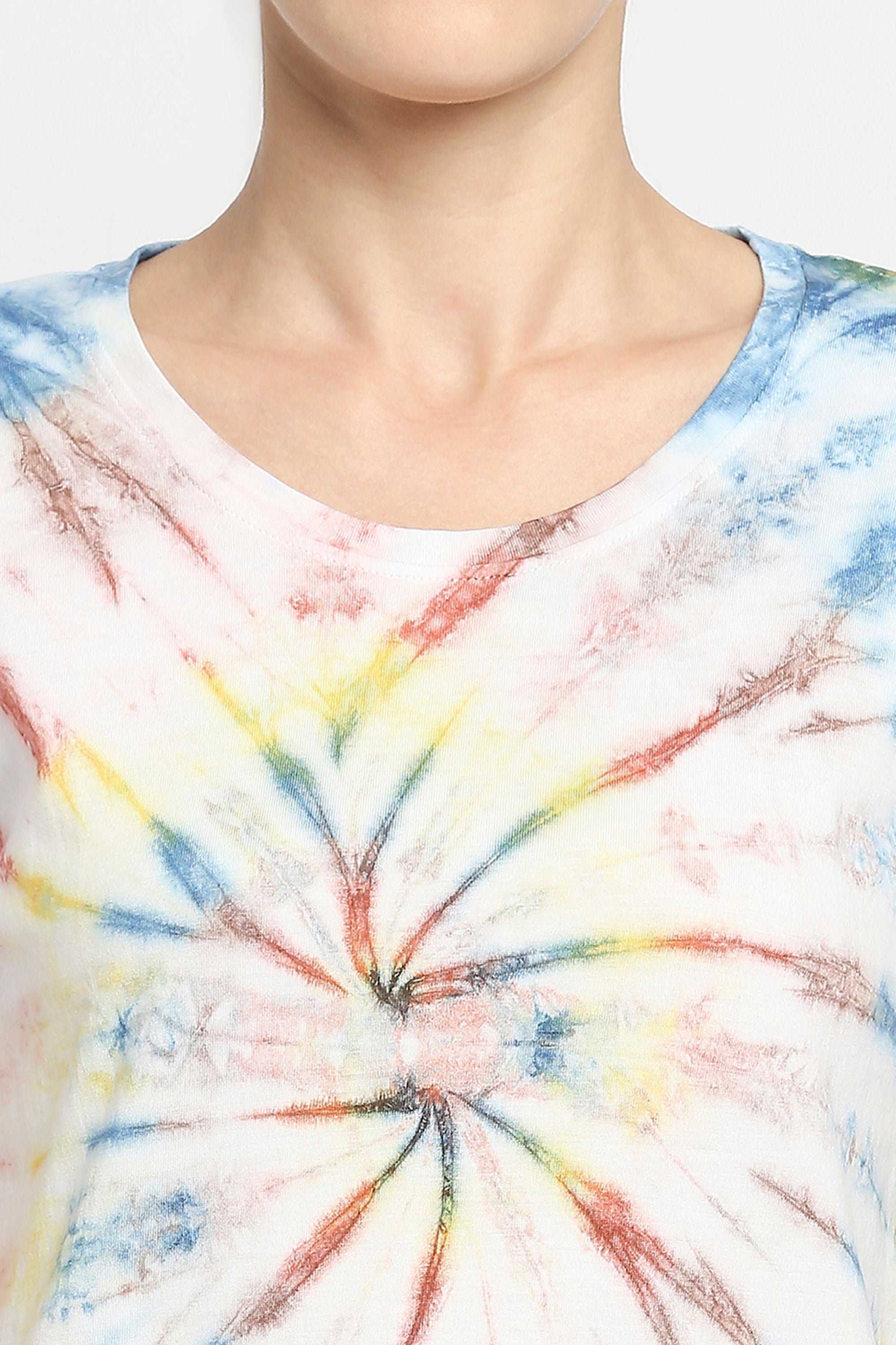 Person wearing Netted shorts + comfort tee made of 100% cotton with blue, yellow, and red spiral tie-dye pattern, visible from neck to upper chest.