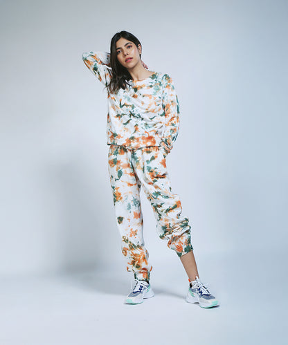Model in the Earthy Tones Sweatshirt / Tee and Comfort Joggers, posing with one hand on her head against a plain background.