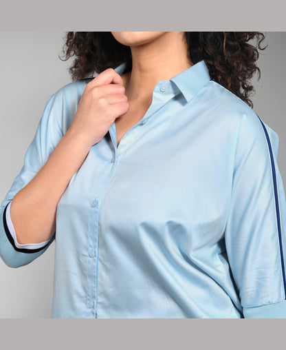 Model wears the Denim Chic Set—a light blue button-up shirt with rolled sleeves, styled with cargo track pants—for an easygoing yet chic look.