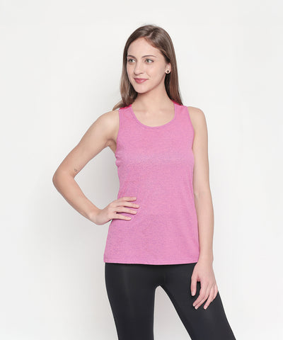 A woman wears a Pink Sleeveless Tank Top with black leggings, standing against a plain white background.