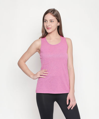 A woman models a Pink Sleeveless Tank Top and black leggings, standing against a plain white background.
