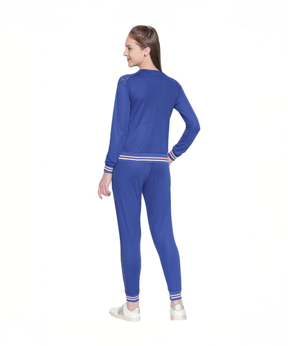 A woman wearing the Royal Blue Color Regular Fit Round Neck Full Sleeve Sweat Top and white sneakers stands with her back to the camera, showcasing a sporty-chic style against a crisp white background.