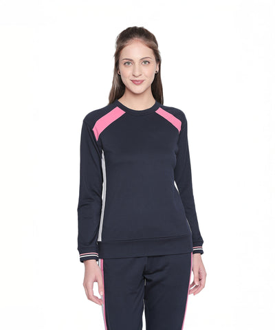 Woman wearing a stylish full sleeve Navy Blue round neck sweatshirt, standing and smiling against a white background.