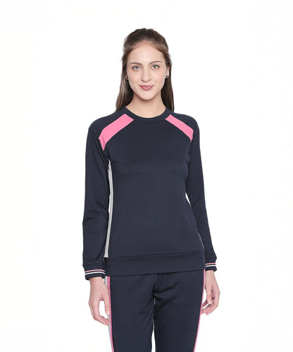 Woman wearing a stylish full sleeve Navy Blue round neck sweatshirt, standing and smiling against a white background.