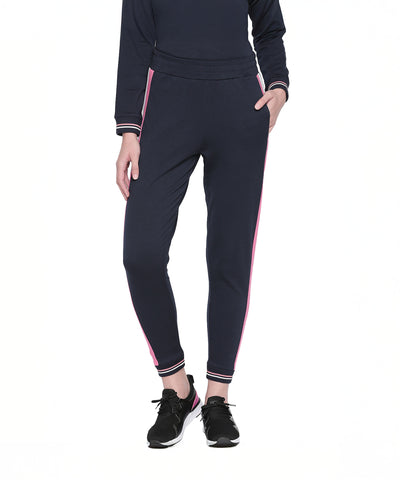 Wearing Navy Blue Joggers with Side Stripe and black sneakers, this look is ideal for women’s active wear during any sports activity. Shown here against a white background.