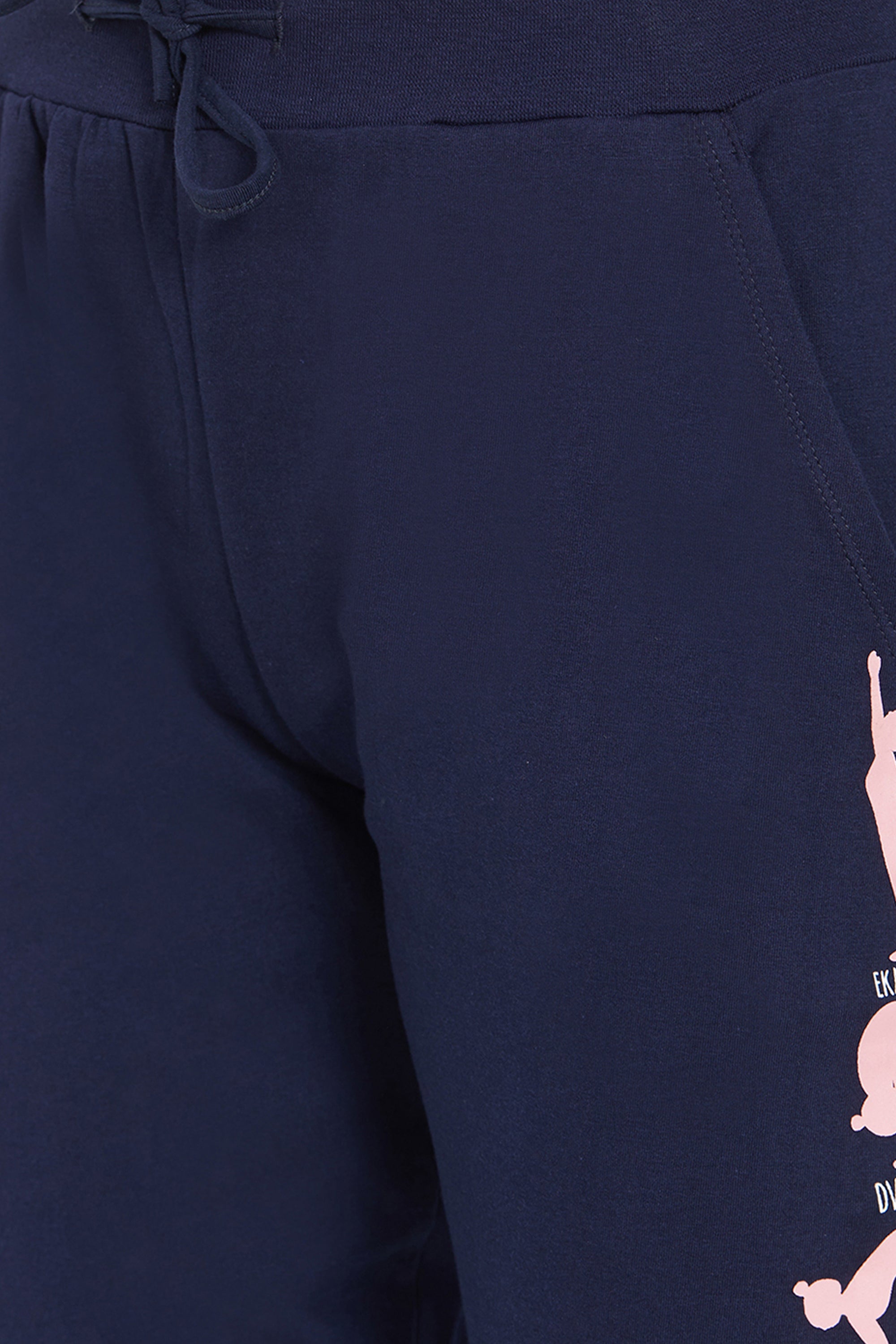 Close-up of Joggers - Ashtanga Series Blue, featuring pink graphic designs on the right thigh and an elastic waistband, perfect for fashionable women.