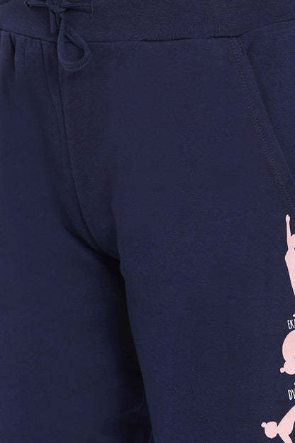 Close-up of Joggers - Ashtanga Series Blue, featuring pink graphic designs on the right thigh and an elastic waistband, perfect for fashionable women.