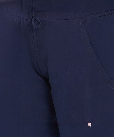 Close-up of Ashtanga Series Blue Joggers featuring a navy blue design and a small pink heart detail near the pocket.