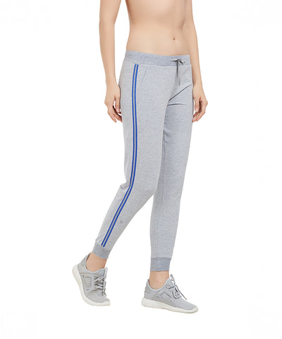 A person wearing Side Stripe Joggers TLC03SS in gray with a tapered fit and matching sneakers, standing on a white background.