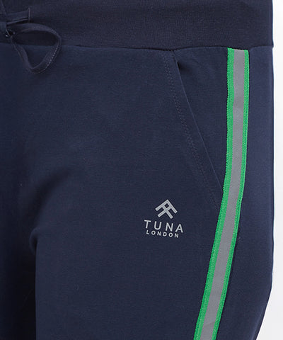 Close-up of Side Stripe Joggers TLC04SS in navy blue, featuring green and grey side stripes and a "Tuna London" logo near the pocket, designed for comfort.