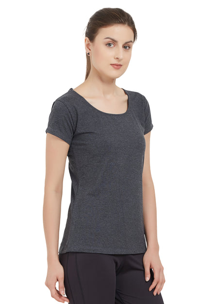 Woman in a TUNA LONDON moisture-wicking Grey Round Neck Tee and black pants stands against a white background.