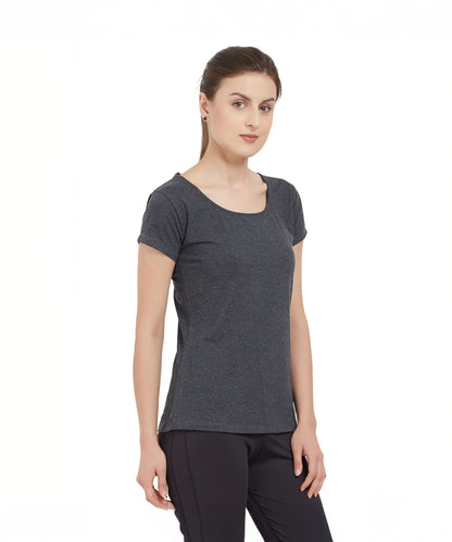 A woman wearing a Grey Round Neck Tee and black pants stands against a plain white background.