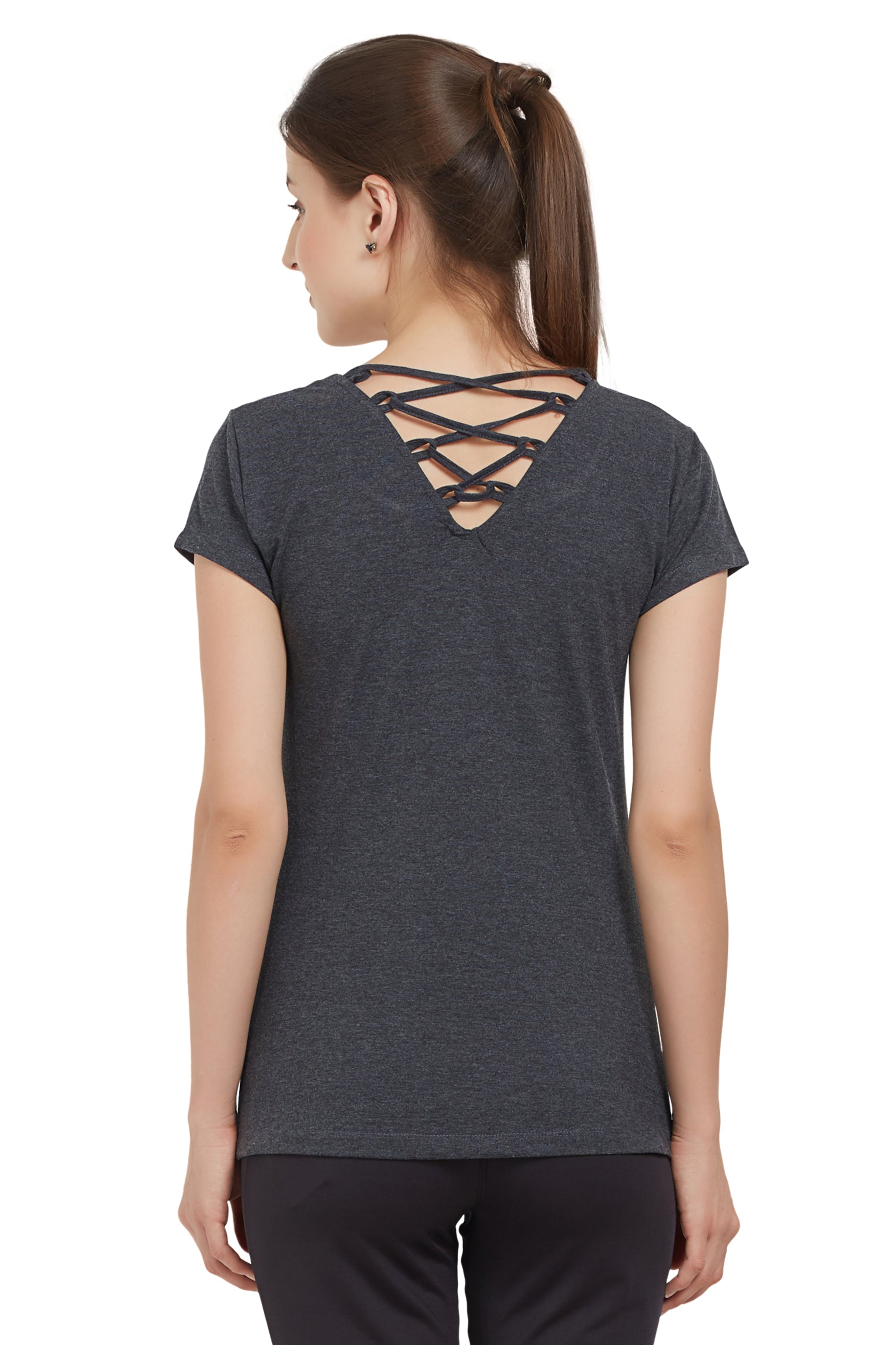 Woman wearing a TUNA LONDON Grey Round Neck Tee with crisscross straps on the upper back and moisture-wicking fabric, facing away.