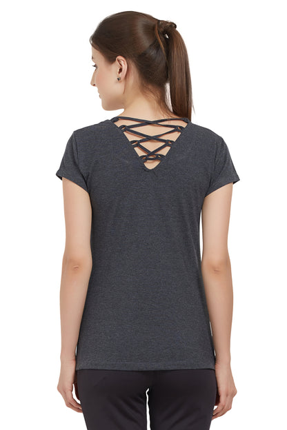 Woman wearing a TUNA LONDON Grey Round Neck Tee with crisscross straps on the upper back and moisture-wicking fabric, facing away.