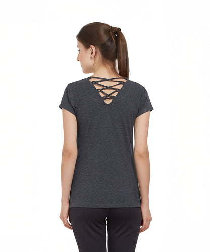 Woman with brown hair in a ponytail wears a TUNA LONDON Grey Round Neck Tee made from cotton lycra, featuring a stylish crisscross back detail, facing away.