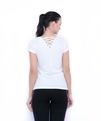Woman facing away, wearing a TUNA LONDON White Round Neck Tee TLC45 with crisscross back detail and black side-striped pants.