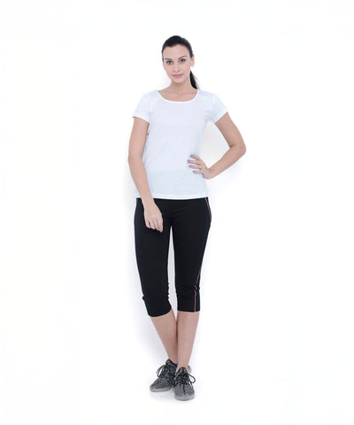 Woman in a TUNA LONDON White Round Neck Tee (TLC45) and black capri leggings, standing against a white background.