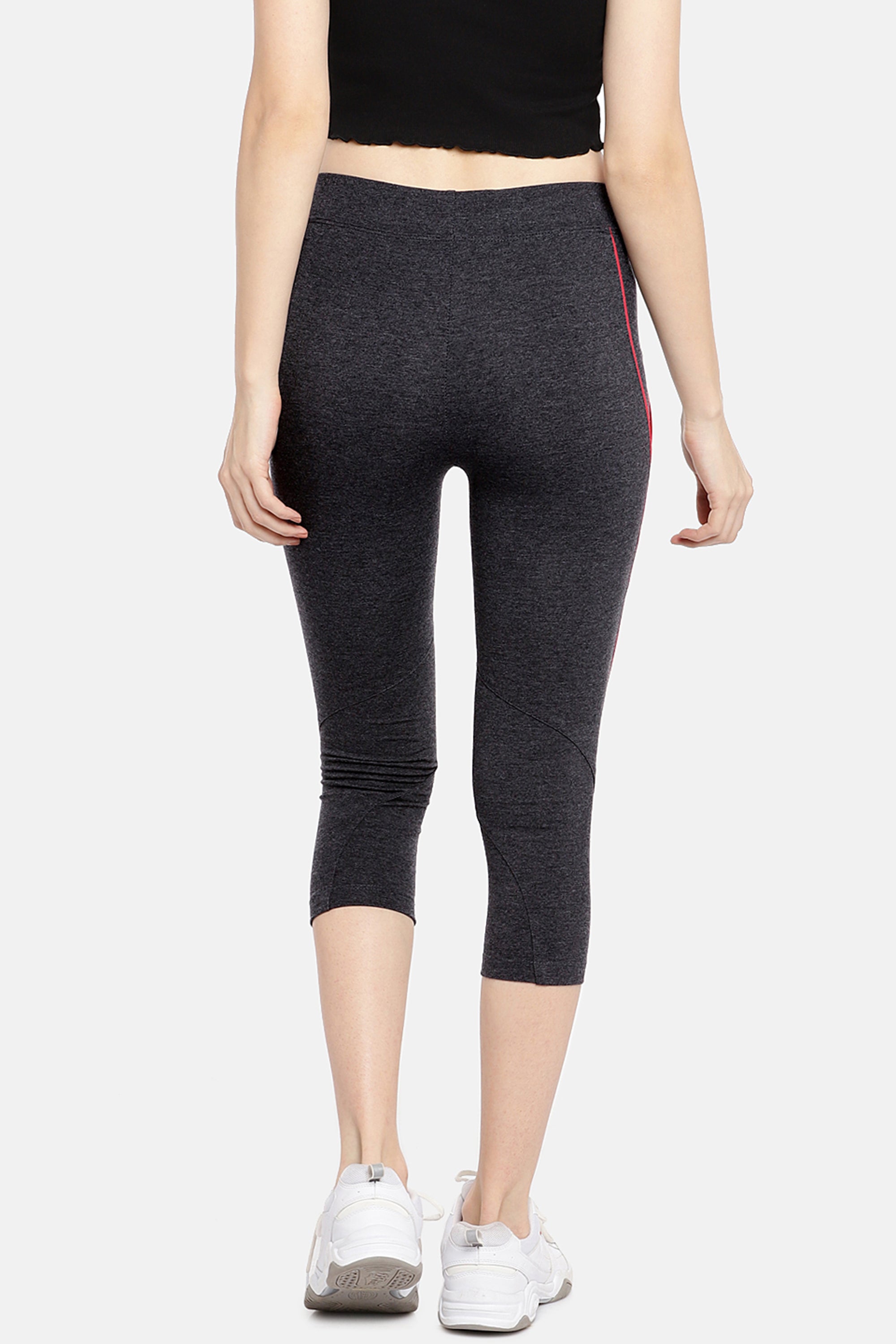 Woman wears Classic Capri TLC67GRY, black capri track pants crafted from Cotton Spandex, paired with white sneakers. Shown from the back against a plain background—ideal for everyday workouts.