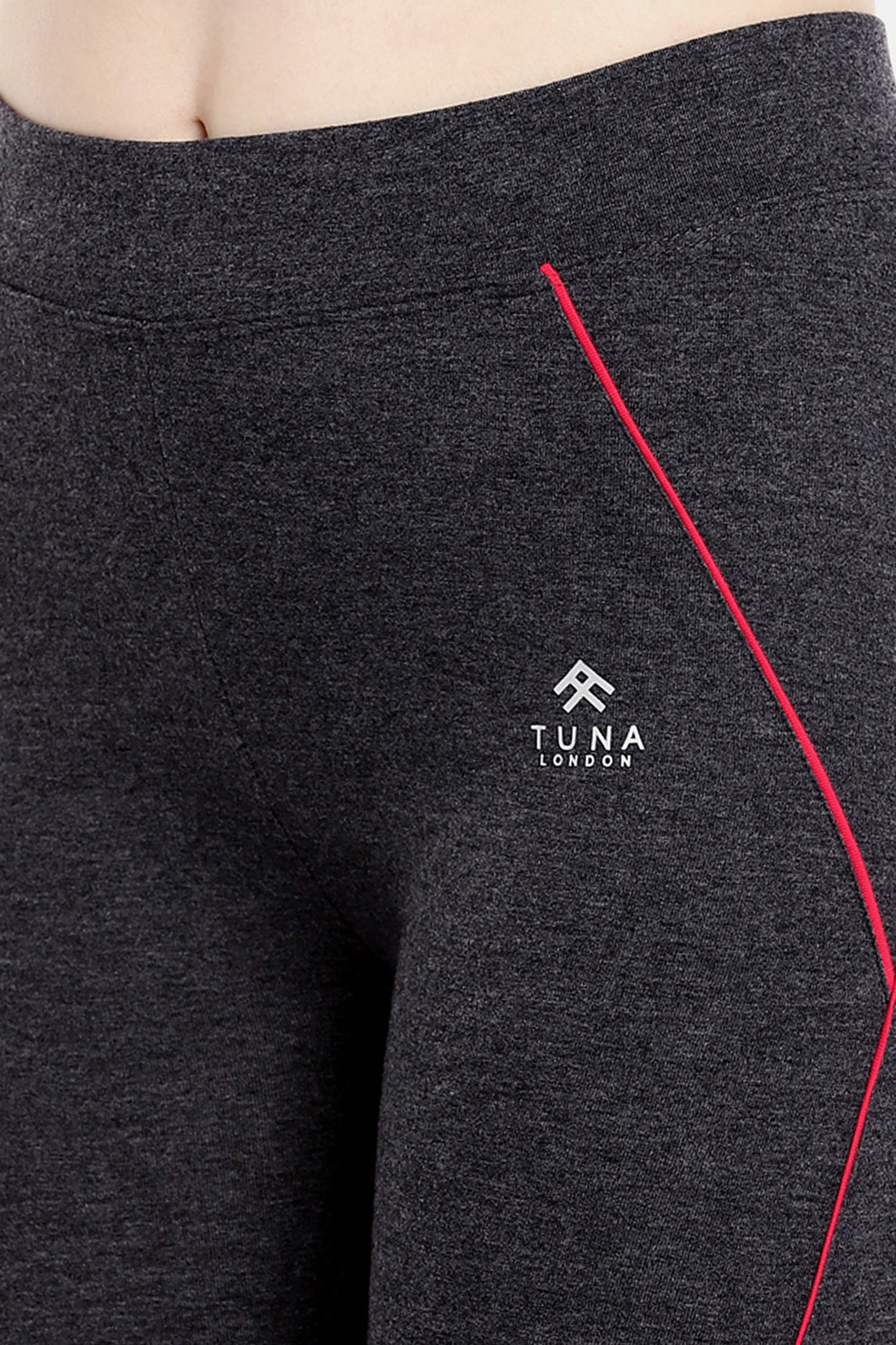 Close-up of the Classic Capri TLC67GRY—dark grey cotton spandex leggings with a red stripe and "Tuna London" logo on the left hip, perfect for everyday workouts.