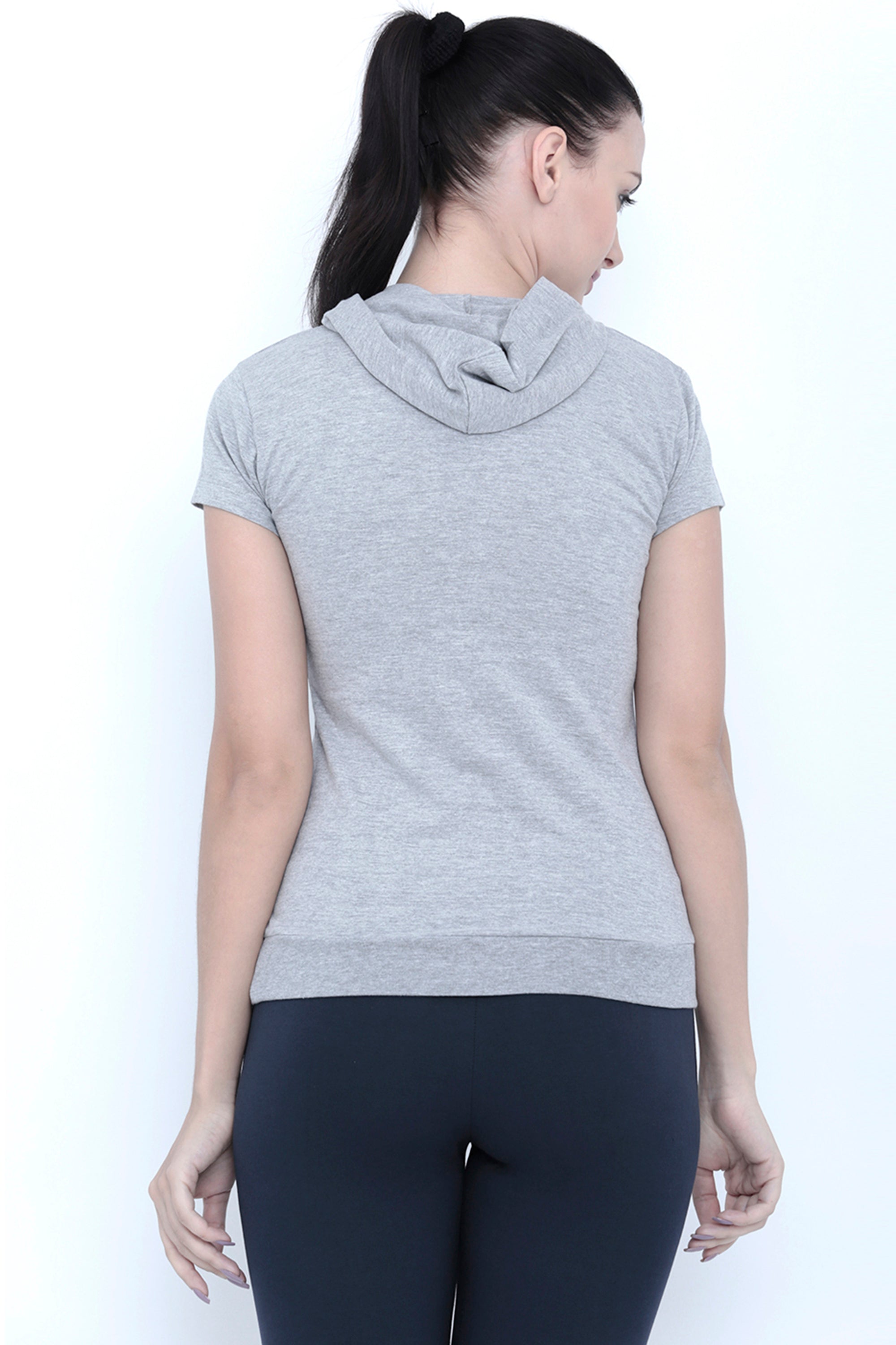 Fitness-conscious women will love the Grey Hoodie, made from 100% cotton, paired with black leggings, as she faces away from the camera.