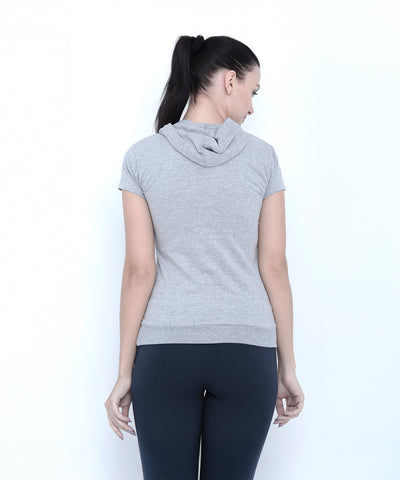 Woman with a ponytail, seen from behind, wears the Grey Hoodie short-sleeve T-shirt and black leggings.
