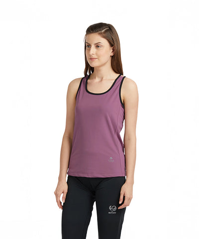 Woman wearing the Mauve Sleeveless Tee with Back Straps, featuring moisture-wicking fabric, paired with black leggings against a white background.