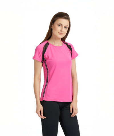 Woman wearing a Tuna London Pink Poly Blend Round Neck Women’s T-Shirt and black pants, standing against a plain white background.