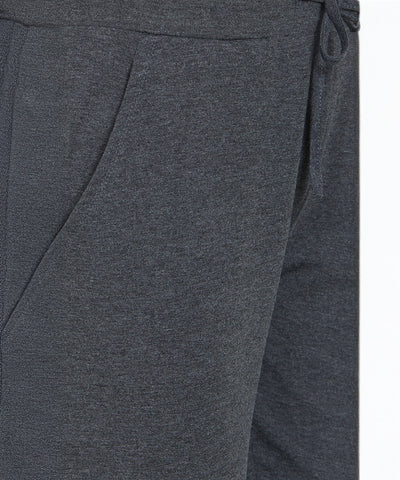 Close-up of Classic Joggers 81 in dark gray, showcasing a visible pocket, waistband, and drawstring for comfort and a slim tapered fit.