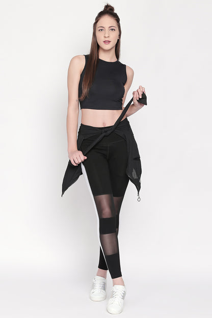 Woman wearing Black and White High Waisted Leggings - LG13 paired with white sneakers, standing against a plain white background.