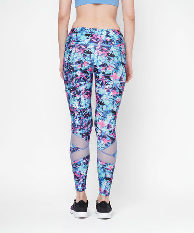 Woman shown from the back against a white background wearing high-waisted Amira Printed Leggings and black sneakers.