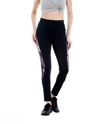 Woman in a gray crop top and Black Sports Leggings G2 featuring an elasticated waistband and side patterns, paired with black sneakers, standing against a white background.