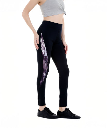 Woman wearing Black Sports Leggings G2 with printed side panel and elasticated waistband, paired with a gray crop top and black sneakers, standing sideways.