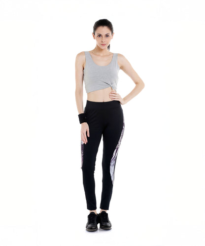 Woman in a gray crop top and Black Sports Leggings G2 with an elasticated waistband, standing against a white background, facing forward.