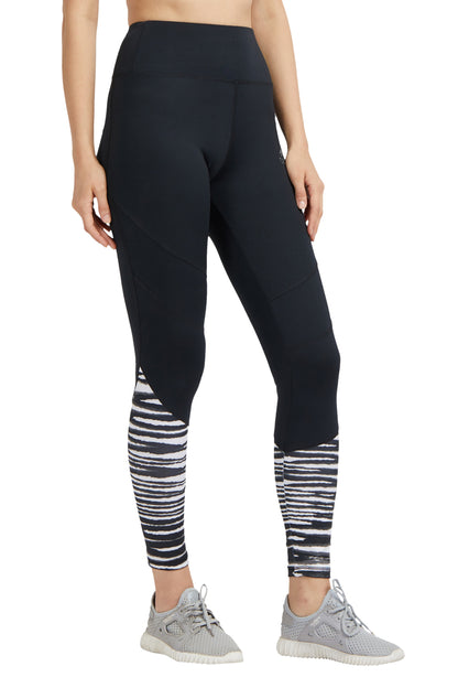 Woman wearing Black High Waisted Compression Sports Leggings With Zebra Print and gray athletic shoes.