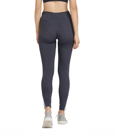A woman wearing Grey High Waisted Sports Leggings G9 and sneakers, shown from the back, stands against a white background.
