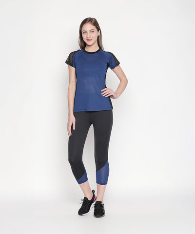 Woman wearing the Sportswear Dark Blue Tracksuit, standing and smiling against a plain white background, ready for an energizing workout.