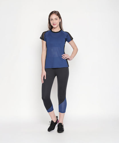 Woman wearing the Sportswear Dark Blue Tracksuit, standing and smiling against a plain white background, ready for an energizing workout.