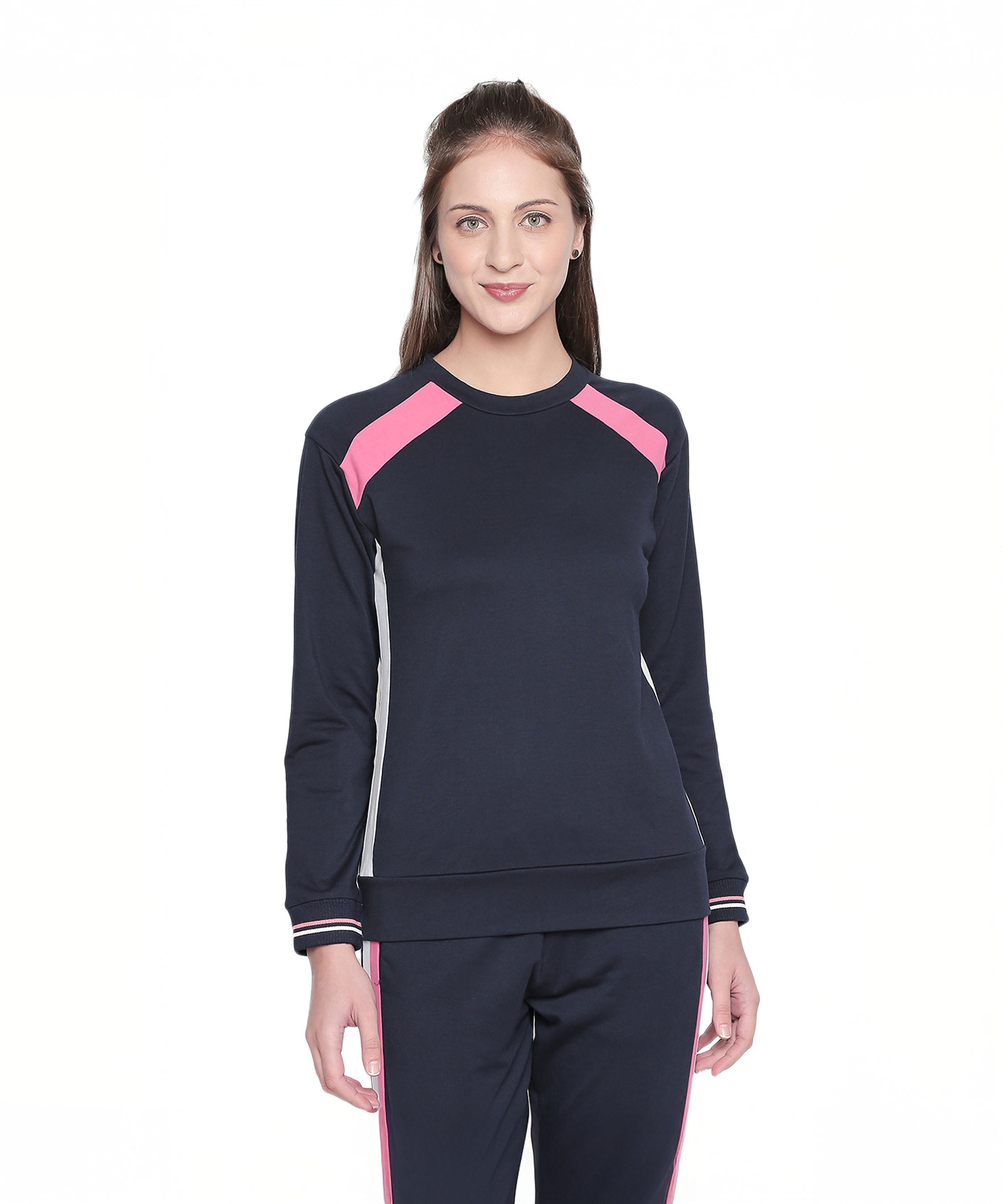 A woman stands smiling in the Sportswear Navy Blue Tracksuit, featuring stylish pink accents—ideal for home workouts or casual outings.