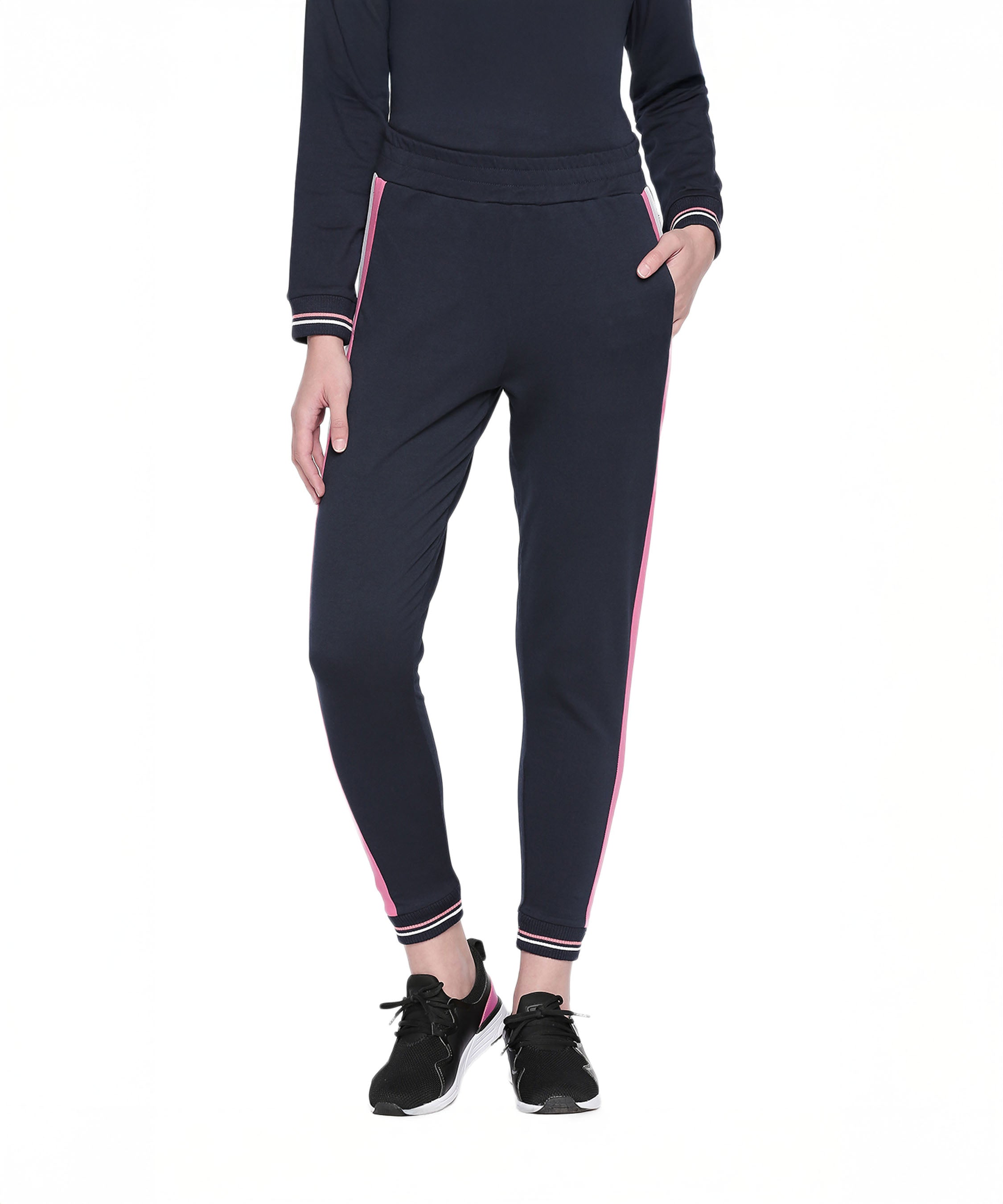Wearing the Sportswear Navy Blue Tracksuit with pink side stripes and black sneakers—ideal for athleisure style or a cozy workout at home.